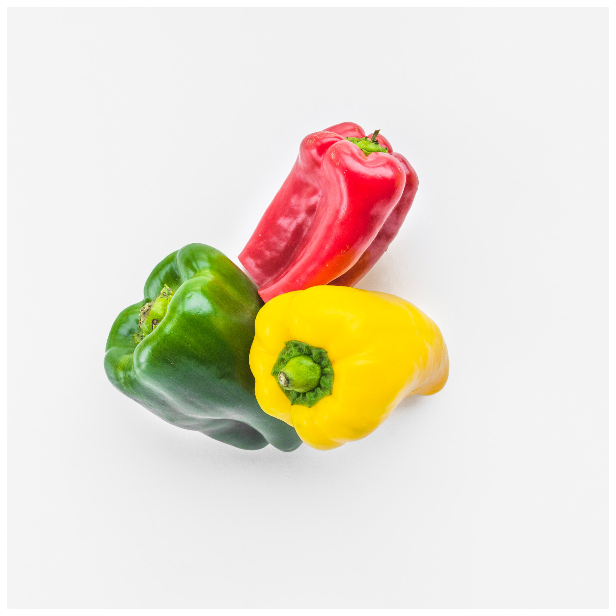 A vibrant mix of red, yellow, and green Bell Peppers from Tulima Farms, Egypt, grown pesticide-free and sold fresh at El Meraki.