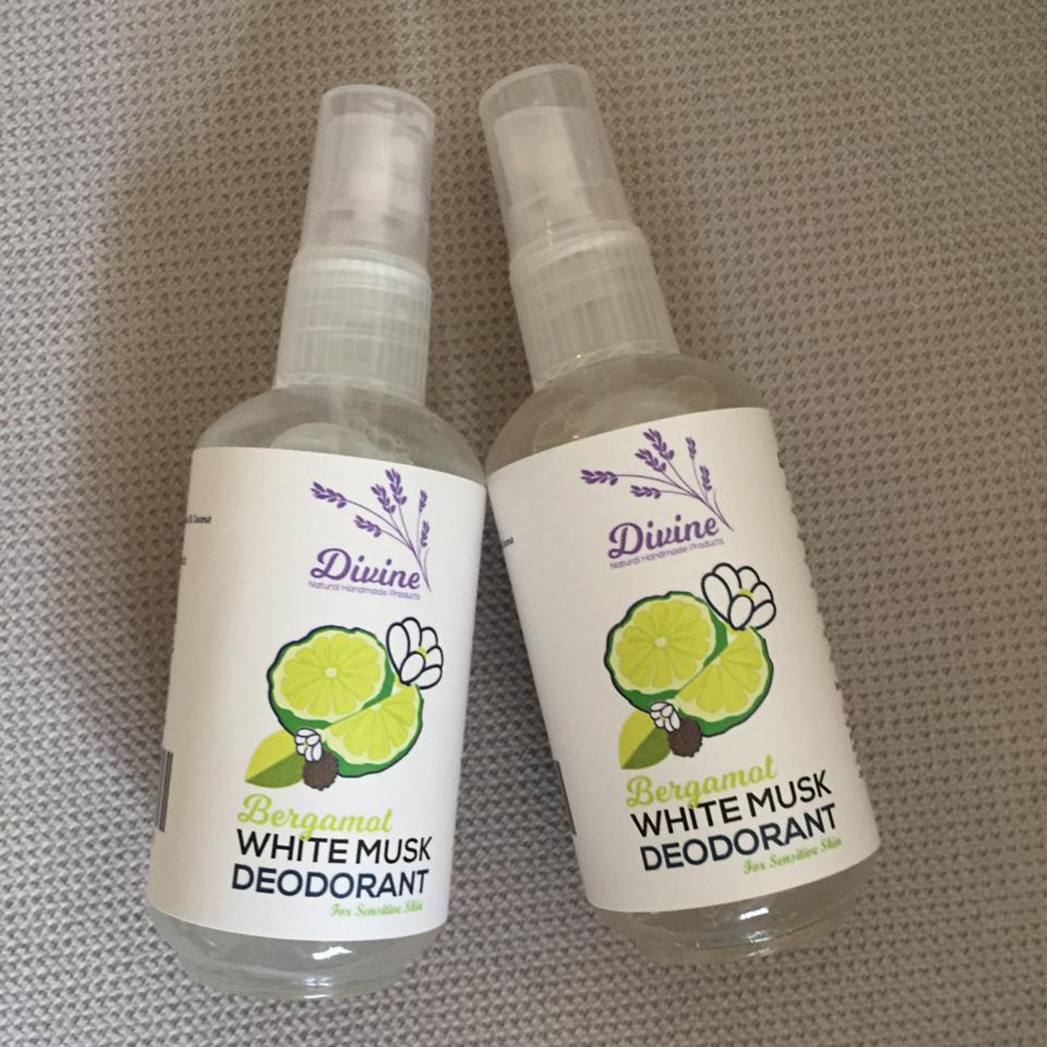 Bergamot White Musk Deodorant by Divine Naturals, available at Elmeraki, displayed in a sleek, eco-friendly package with fresh bergamot and lavender sprigs.