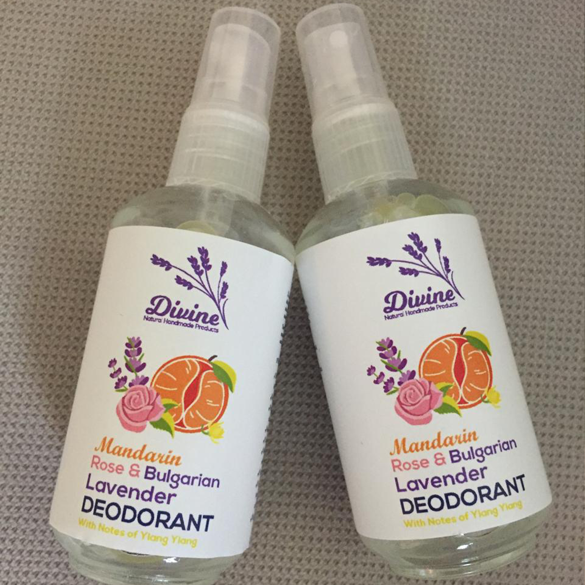Mandarin Rose Deodorant by Divine Naturals, available at Elmeraki, displayed in a sleek, eco-friendly package with fresh rose petals and citrus fruits.
