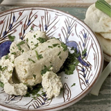 Old Cheese by Tabi3y, available at Elmeraki, displayed on a cheese board with crackers and fruits.