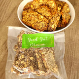Roll With It Crackers from Good Gut Mama, available at Elmeraki, displayed in a bowl with nuts and seeds.