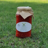 Tomato Sauce by Tabi3y, available at Elmeraki, displayed in a jar with fresh tomatoes and herbs.