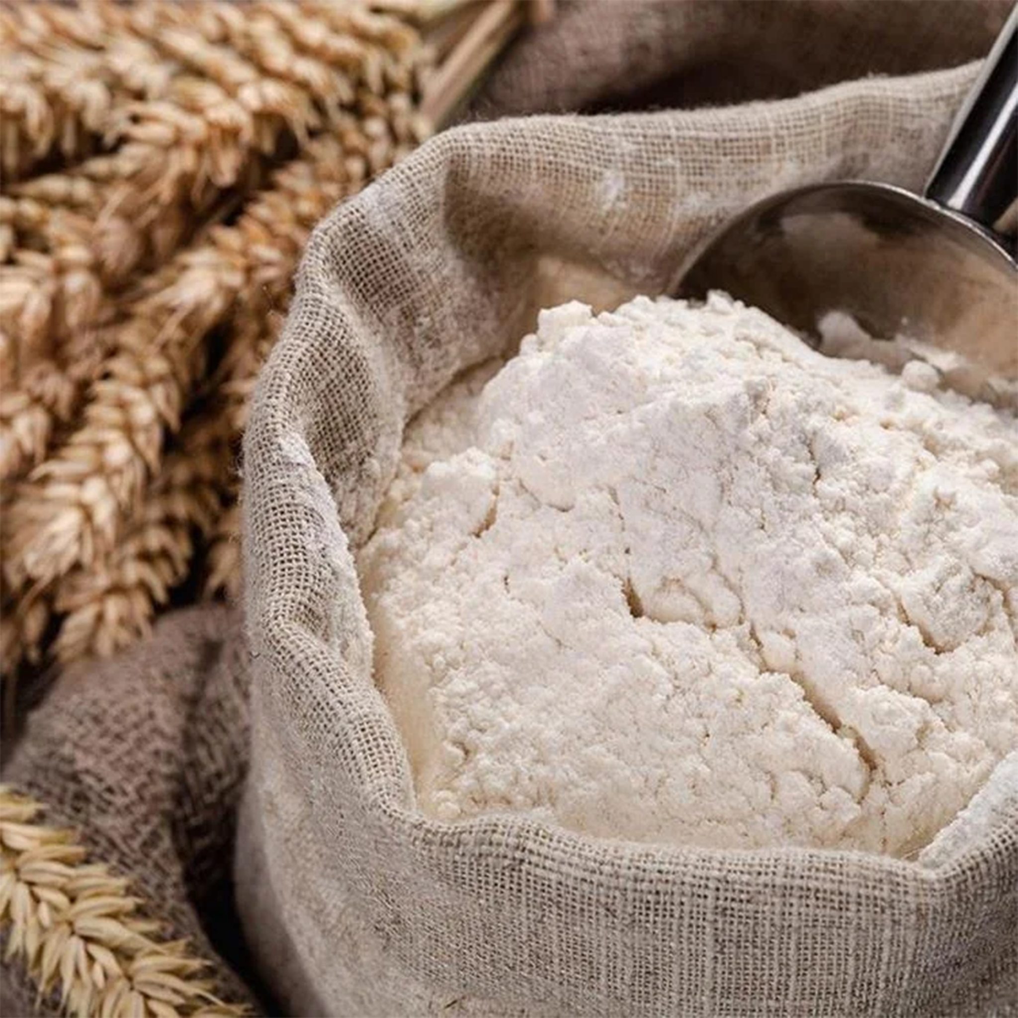 White Flour by Tabi3y, available at Elmeraki, displayed in a bag with fresh baked goods like cakes and cookies.