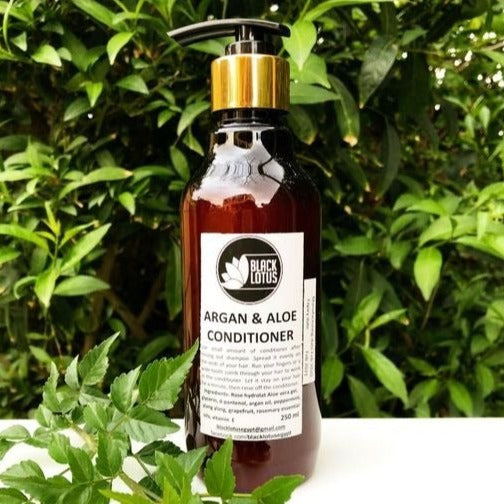 Black Lotus Argan and Aloe Vera Hair Conditioner bottle for deep nourishment and frizz control. Produced in Egypt.