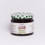Jar of Dried Tomatoes in Olive Oil from Bostan Set El Hosn, 300 gm, featuring a green and white checkered lid and a label with both Arabic and English text.