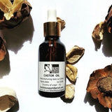 Bottle of cold-pressed castor oil for hair and skin by Black Lotus, made in Egypt.