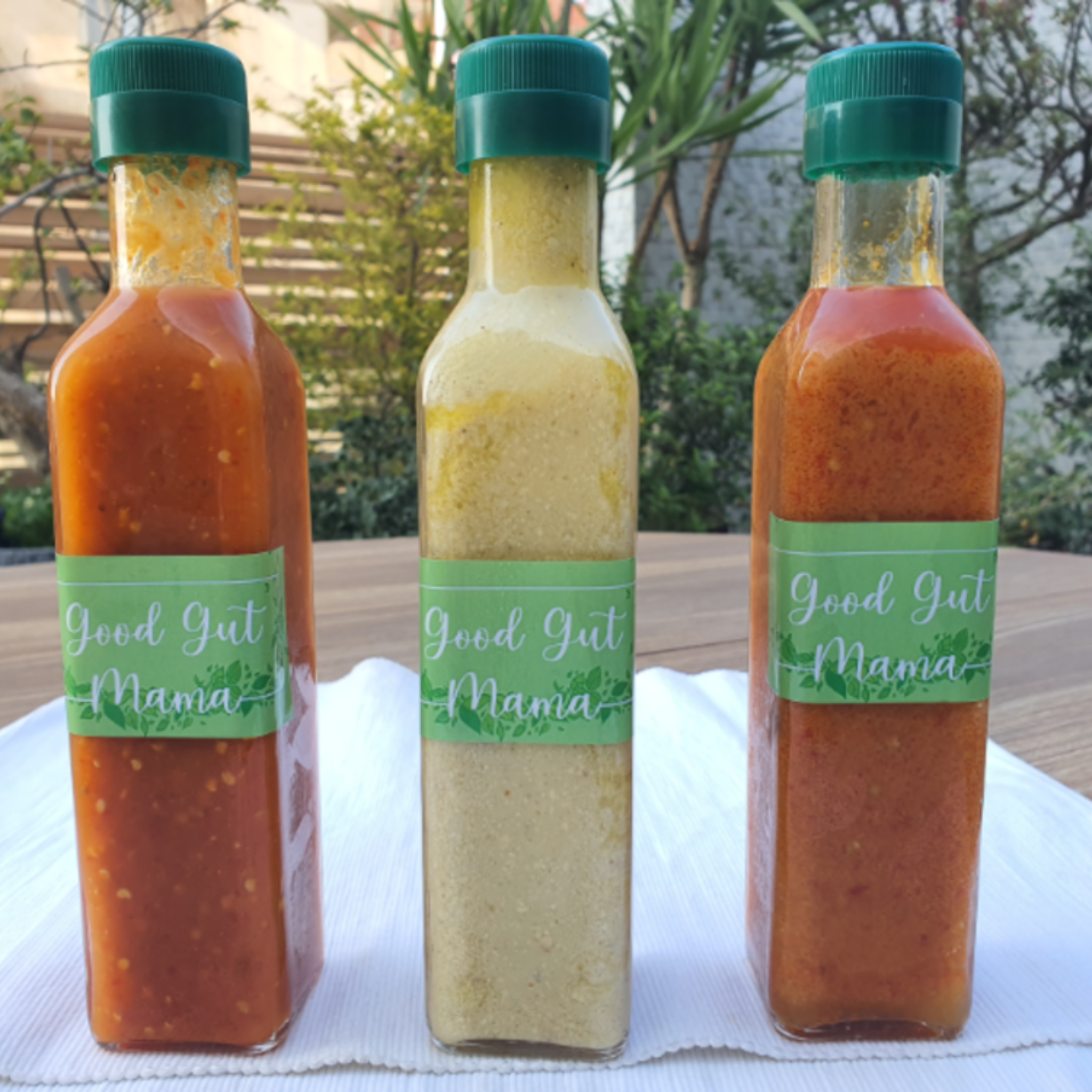 Bottle of Good Gut Mama Fermented Sriracha Sauce from Egypt, showing the vibrant red, unstrained chili sauce.