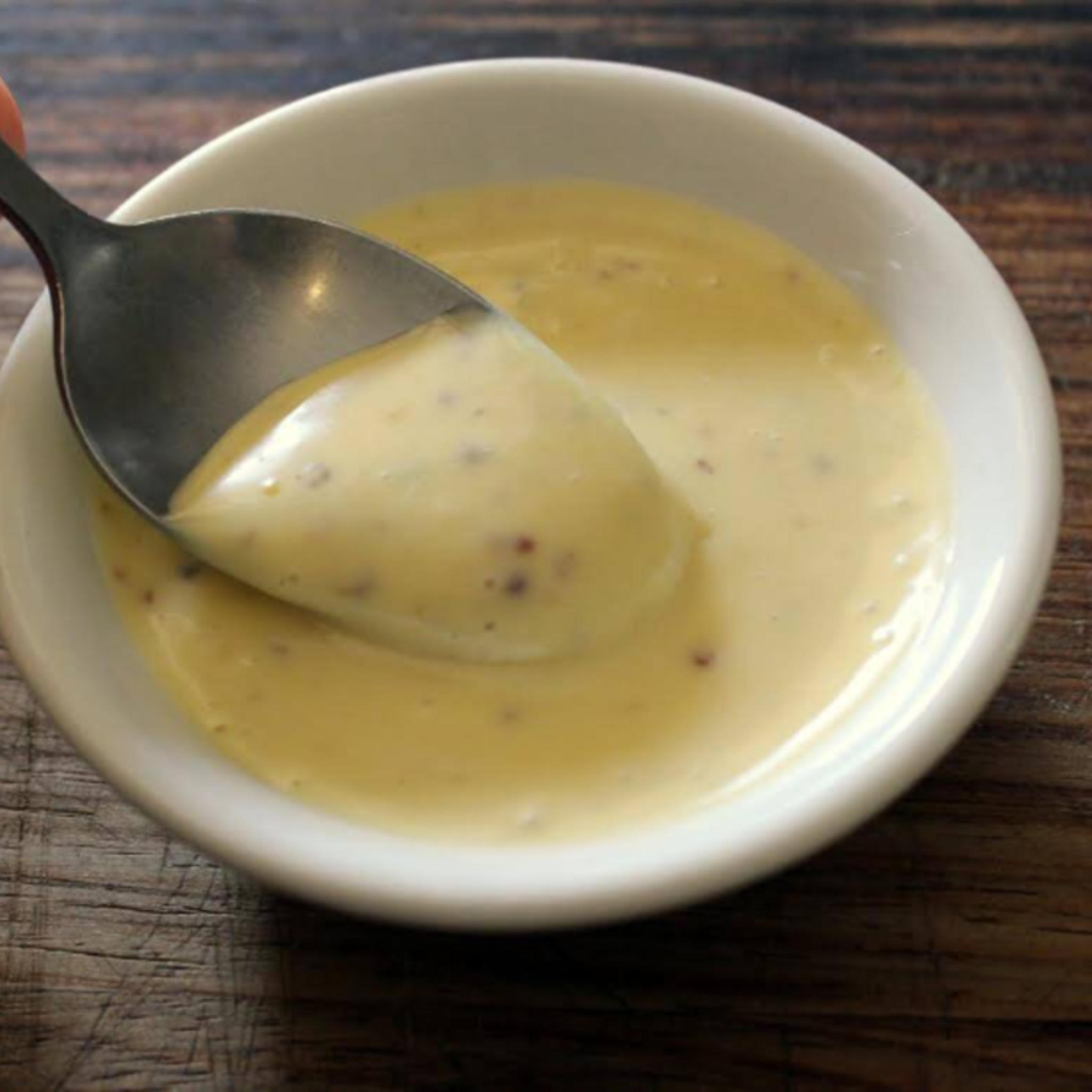 Jar of creamy Good Gut Mama Mayonnaise made in Egypt, with a spoonful showing its rich texture.