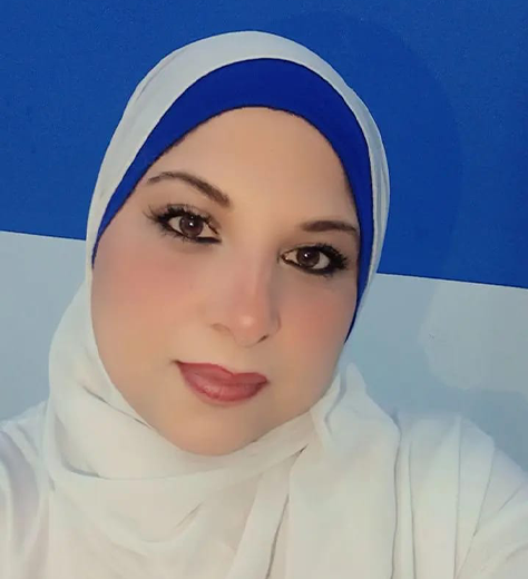 Doaa Fouad, certified aesthetician in Cairo, wearing a white lab coat and holding premium Swiss skincare products in her modern clinic.