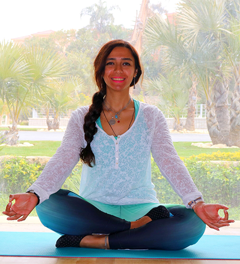 Yogini Sally guiding students in Air Yoga poses using a blue hammock, demonstrating aerial inversions with proper alignment.