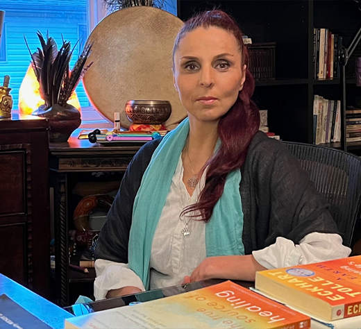 Faten Qalawi guiding a client through Depth Hypnosis, using a drum for shamanic journeying in a serene therapy space.