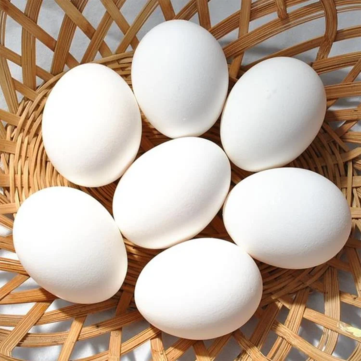 Baladi Eggs by Tabi3y, available at Elmeraki, displayed in a carton with fresh herbs and vegetables.