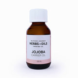 Blessed Journey Pure Golden Jojoba Oil in a dark glass bottle from El Meraki, a versatile balancing oil for face, hair, and skin care.