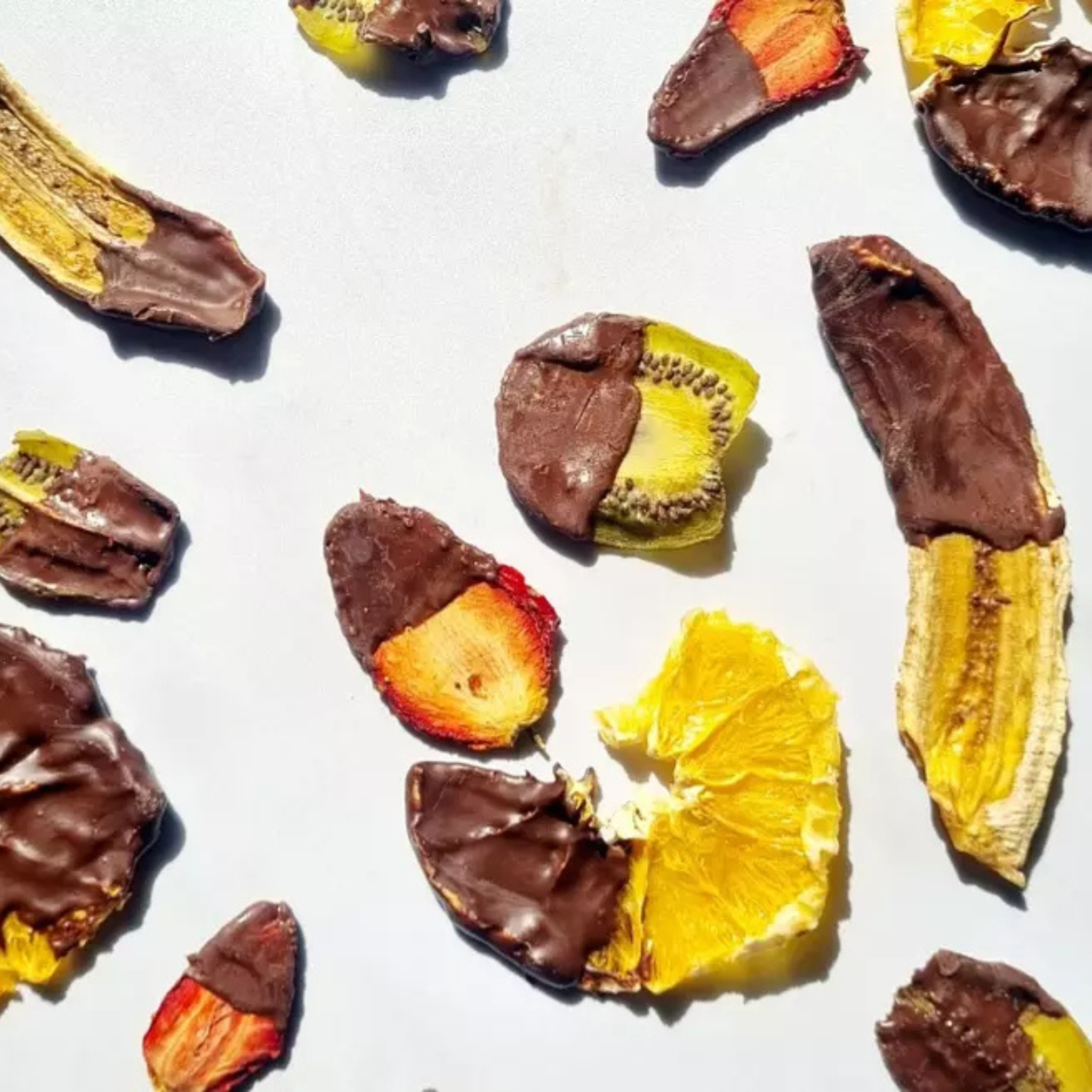 A pack of Dansnack Fruit Chips Mix with mango, pineapple, watermelon, and orange - a natural, dehydrated snack from Egypt.