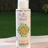 Face Serum by Divine Naturals, available at Elmeraki, displayed in a sleek bottle with fresh lavender and eucalyptus leaves.