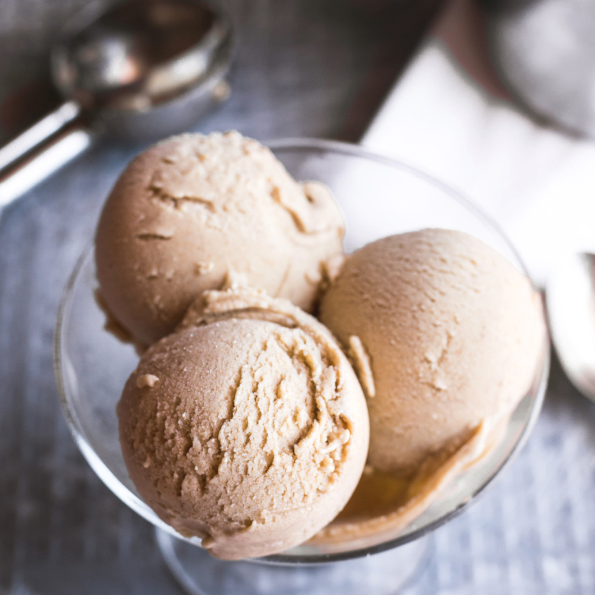 assortment of 10 ice cream flavors in tubs – chocolate, mango, pistachio, matcha, and more.