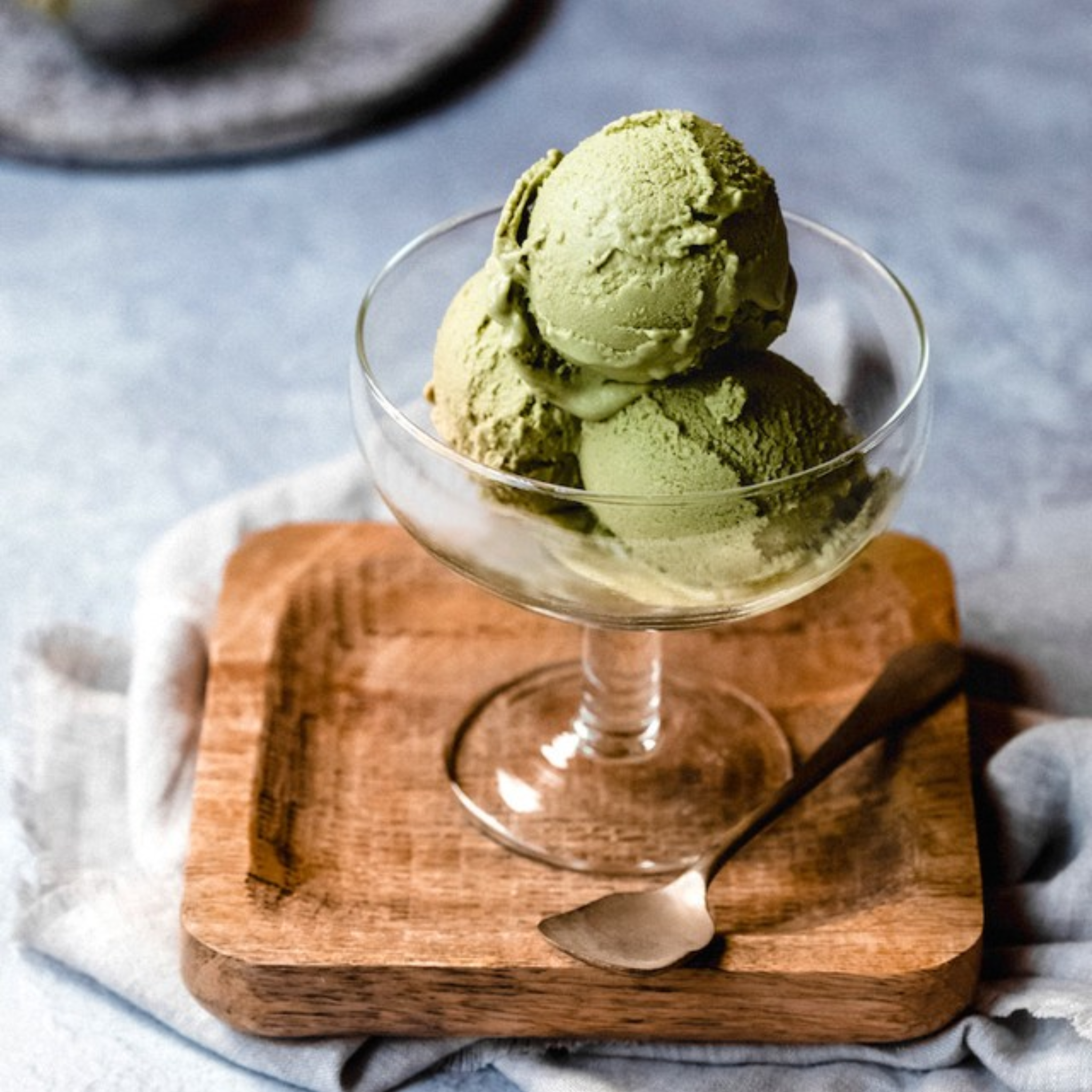 assortment of 10 ice cream flavors in tubs – chocolate, mango, pistachio, matcha, and more.