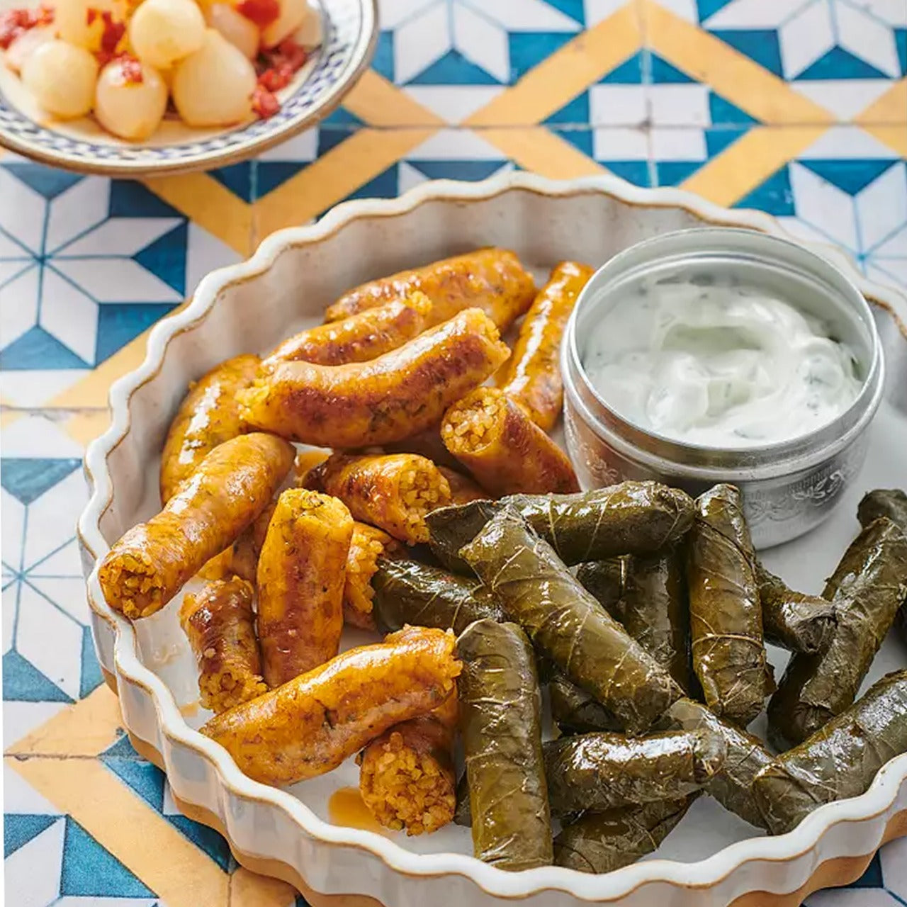 A plate of fried Komm El Dikka Stuffed Beef Mombar, a traditional Egyptian sausage, from El Meraki.