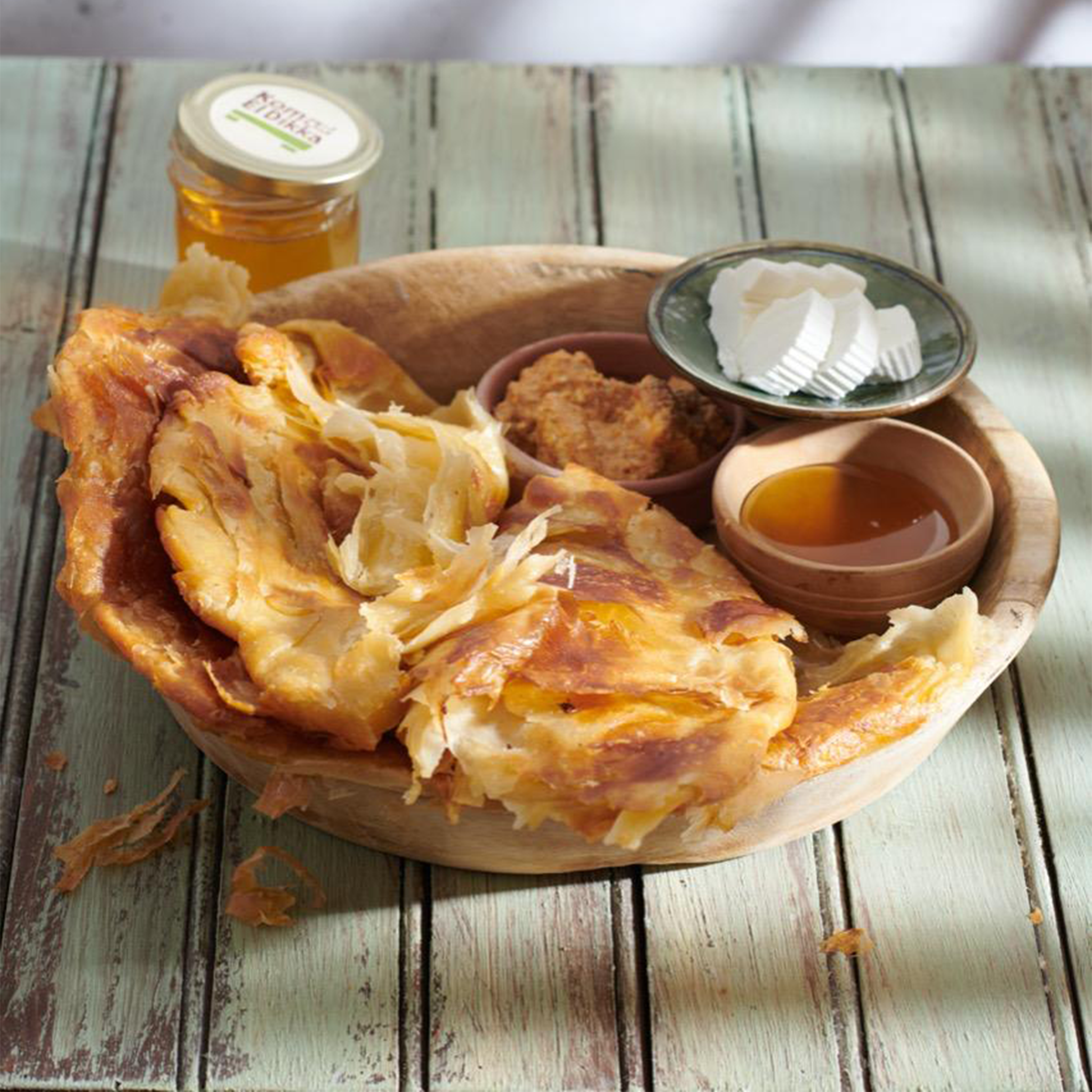 A fresh, flaky Balady Feteer, a traditional Egyptian layered bread from Komm El Dikka, delivered by El Meraki.