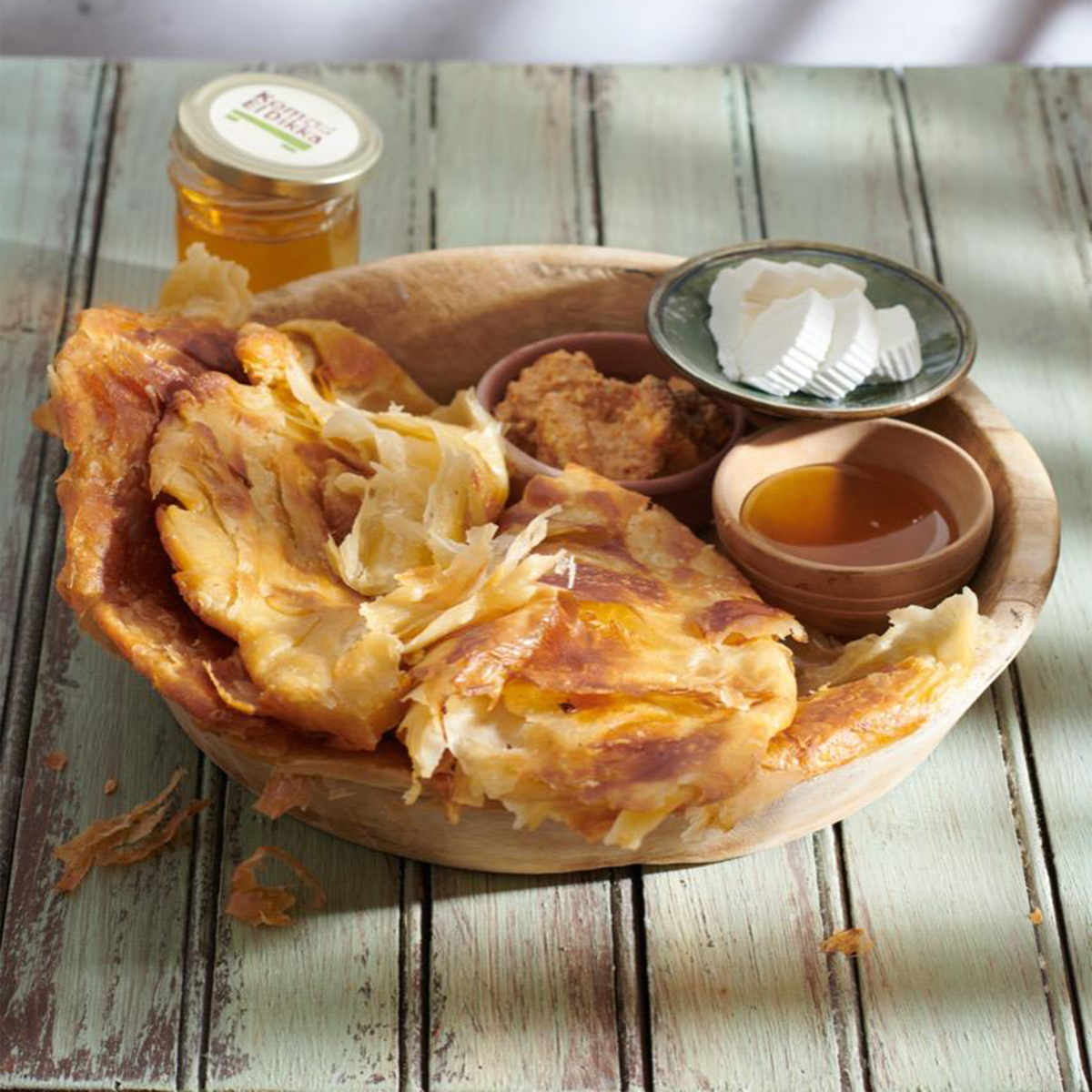 A fresh, flaky Balady Feteer, a traditional Egyptian layered bread from Komm El Dikka, delivered by El Meraki.