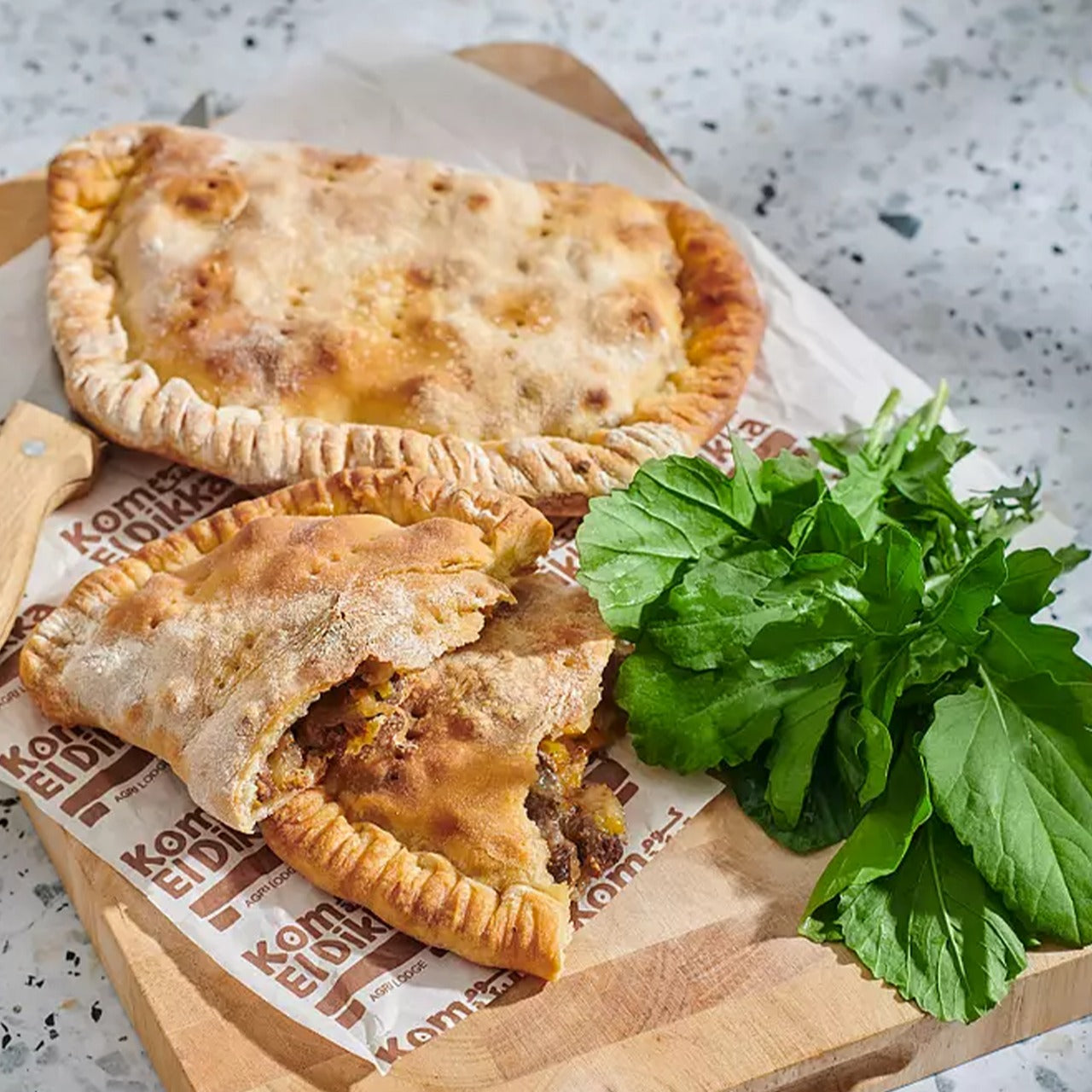 A golden, baked Komm El Dikka Sogok & Cheese Pie, a frozen savory Egyptian pastry from El Meraki.