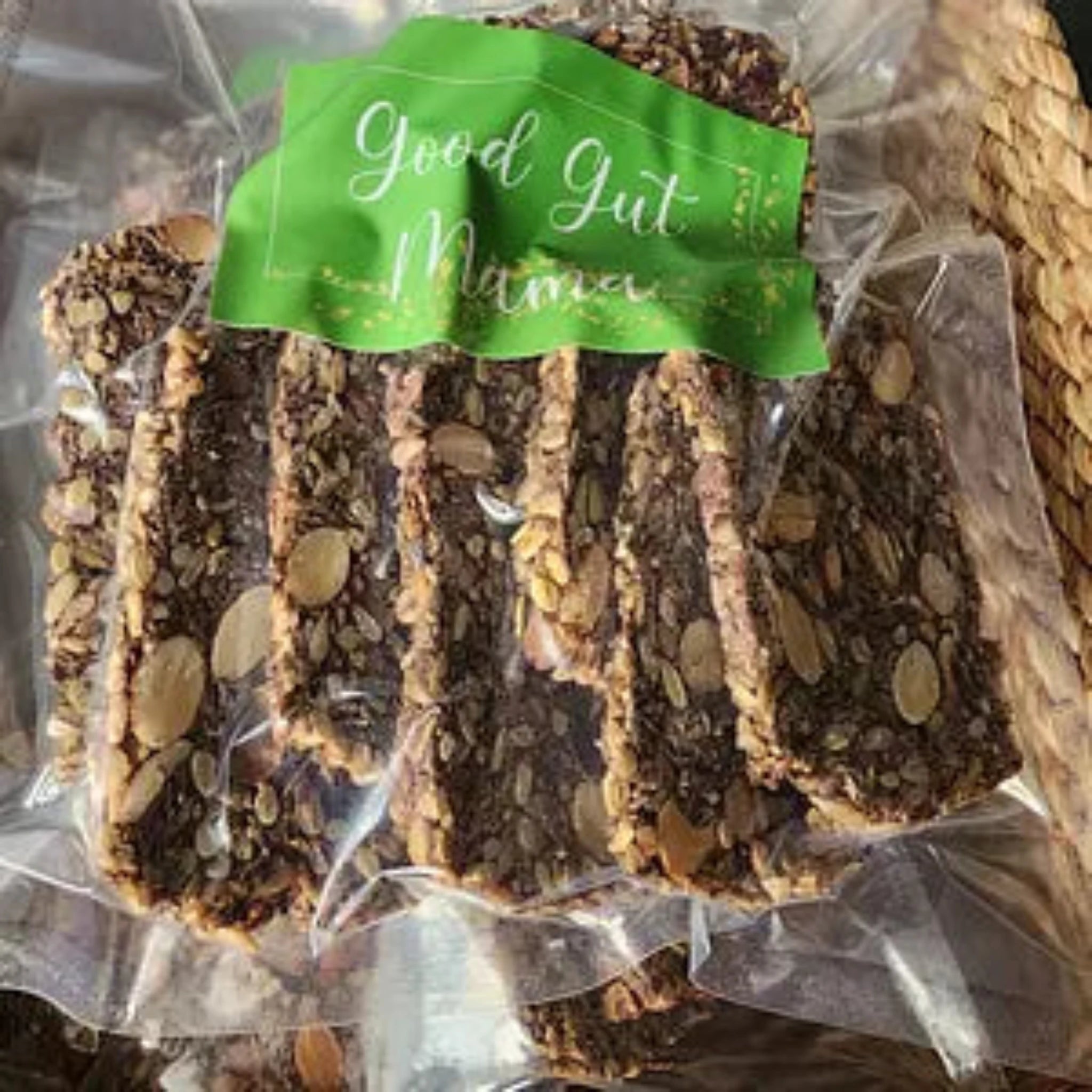 Nourish Me Crackers from Good Gut Mama, available at Elmeraki, displayed in a bowl with nuts and seeds.