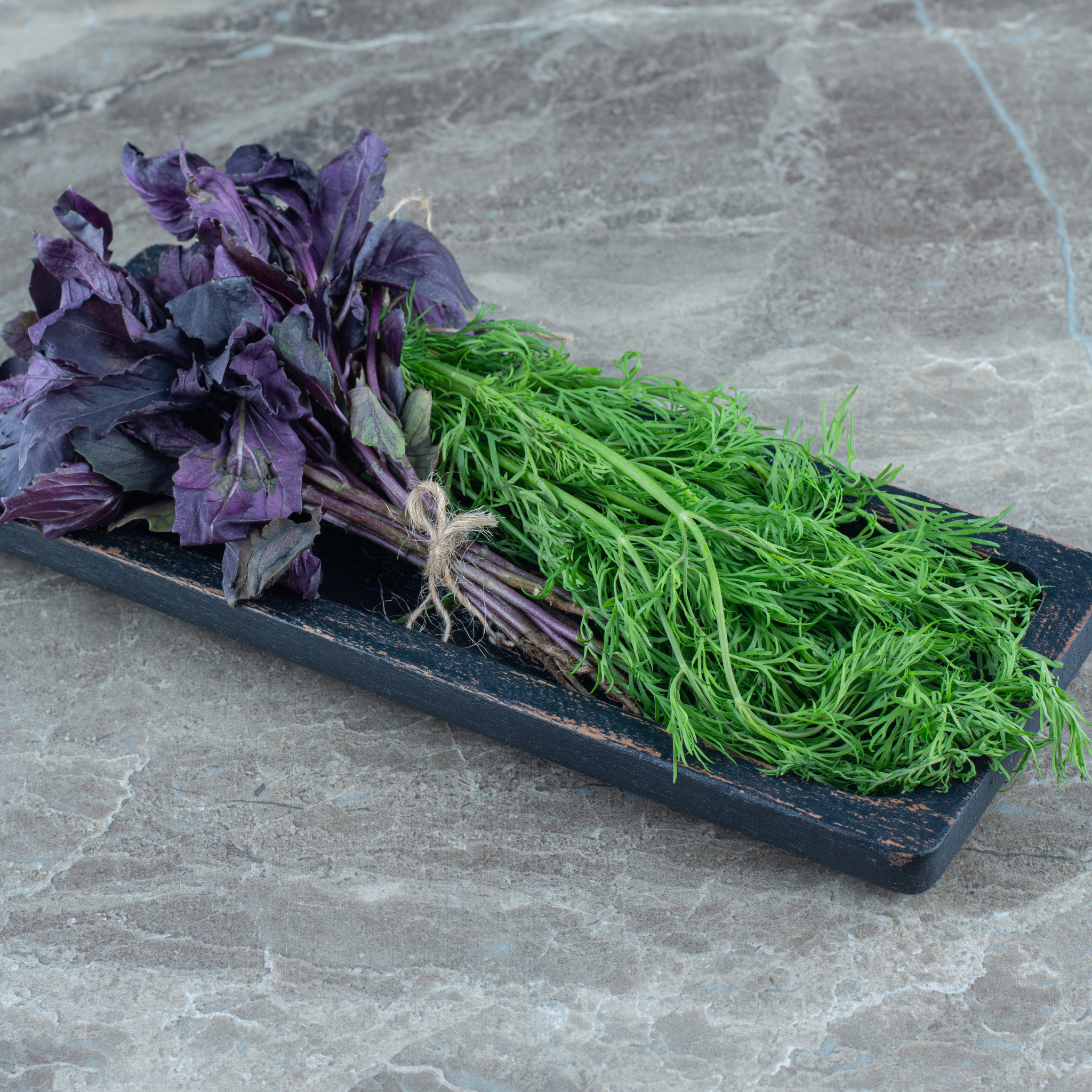 Fresh bunch of vibrant purple basil from Tulima Farms, an aromatic and pesticide-free herb.