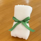A stack of Tunic's white 100% cotton cheese drainage cloths for making labneh, yogurt, and feta in an Egyptian kitchen.