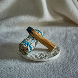 White sage and palo santo bundle with ceramic holder for home cleansing and meditation