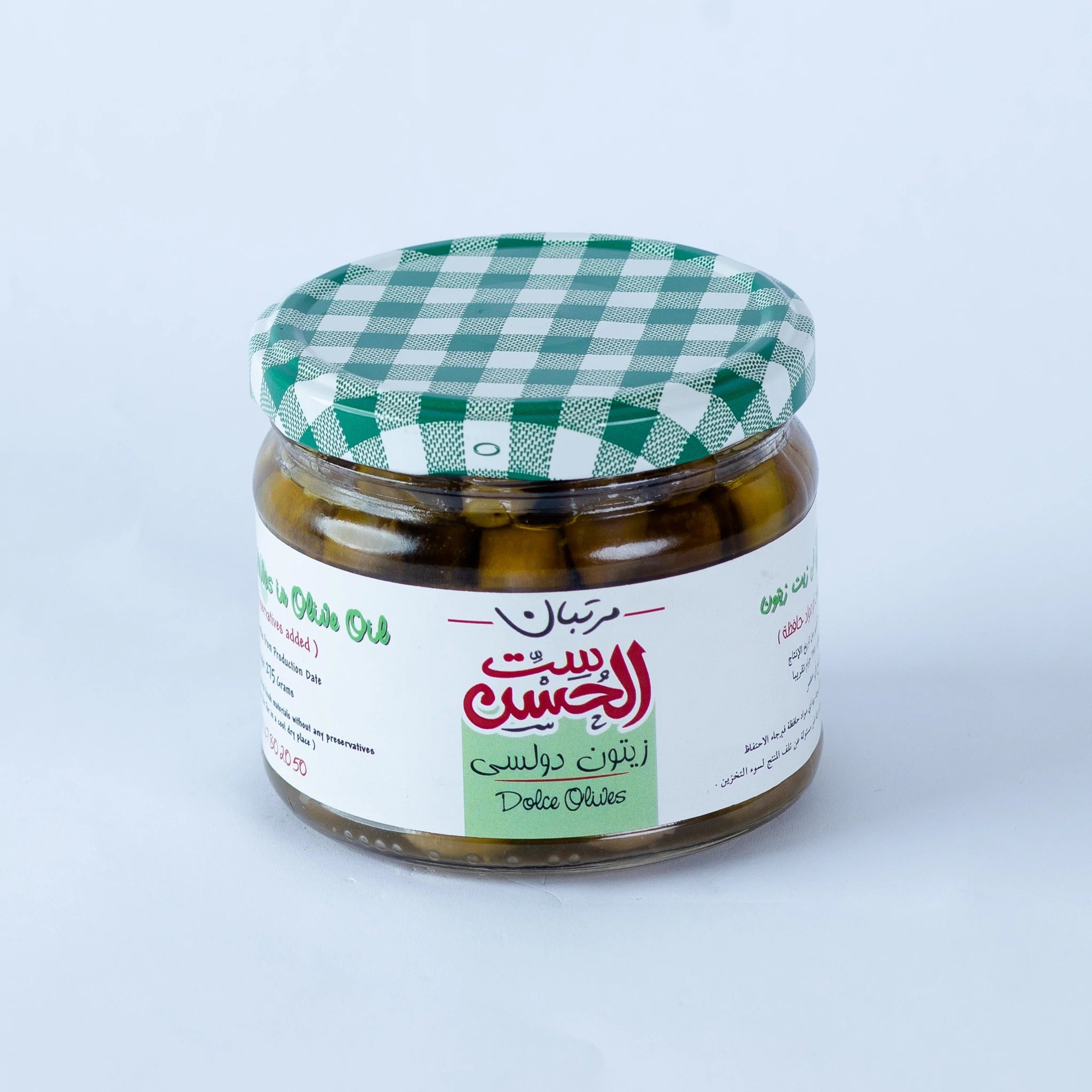 Jar of Dolci Green Olives from Bostan Set El Hosn, pickled using only salt and without any additives, featuring a green and white checkered lid and a label with both Arabic and English text