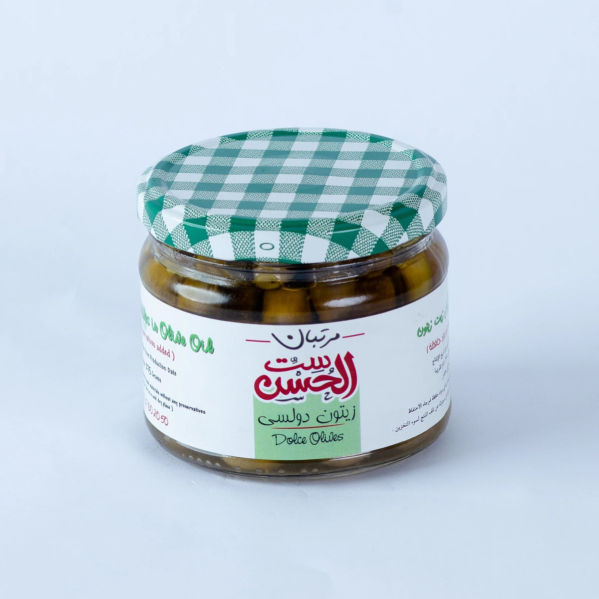 Jar of Dolci Green Olives from Bostan Set El Hosn, pickled using only salt and without any additives, featuring a green and white checkered lid and a label with both Arabic and English text