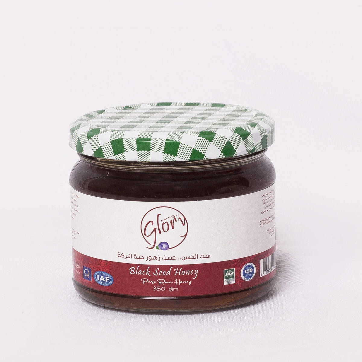 Jar of Glory Raw Black Seed Honey from Bostan Set El Hosn, featuring a green and white checkered lid and a label with both Arabic and English text