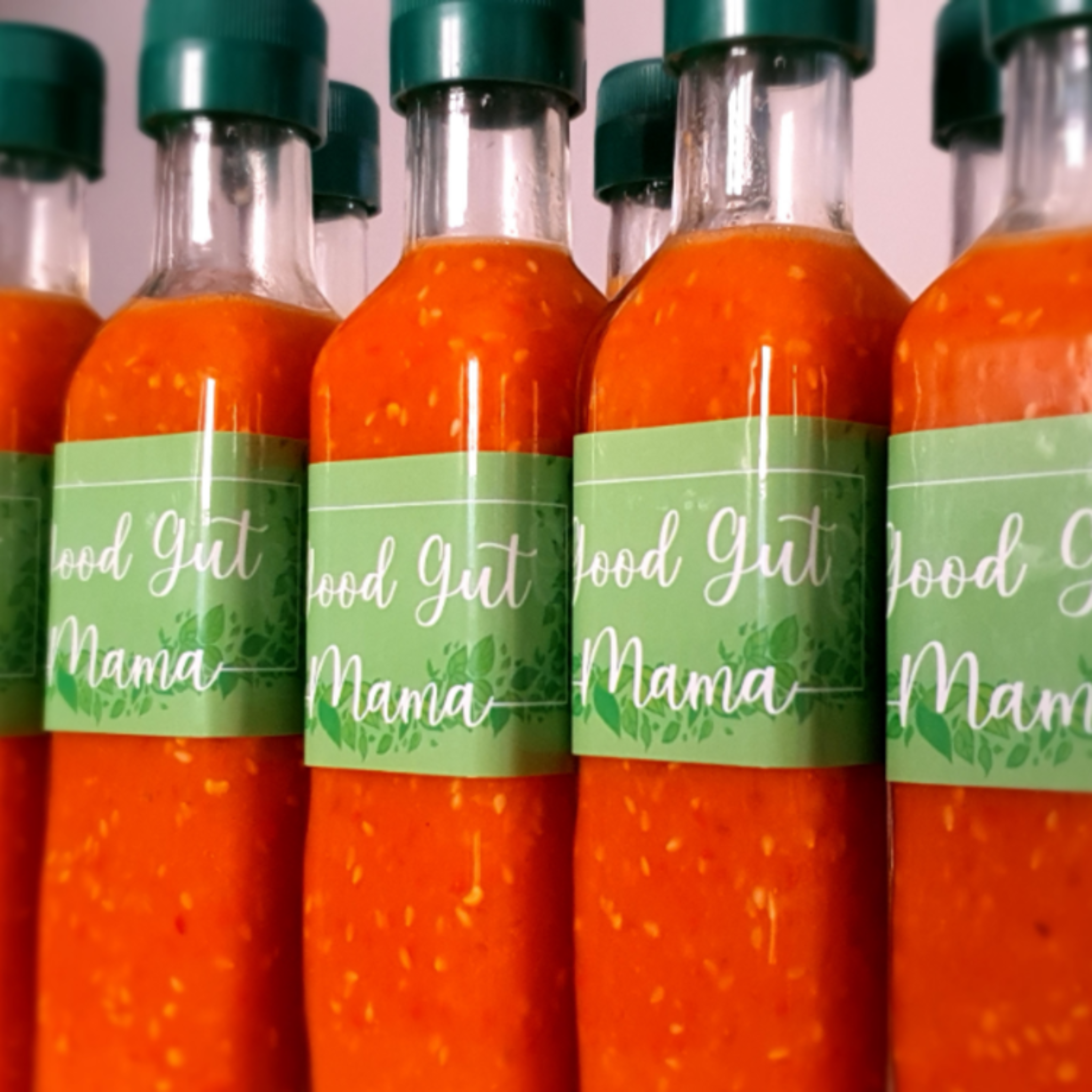 Bottle of Good Gut Mama Fermented Sriracha Sauce from Egypt, showing the vibrant red, unstrained chili sauce.