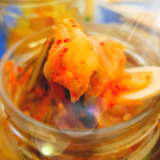 Jar of Good Gut Mama Korean Kimchi made in Egypt, showing fermented napa cabbage with carrots and spices.